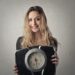 Girl holding a weighing machine