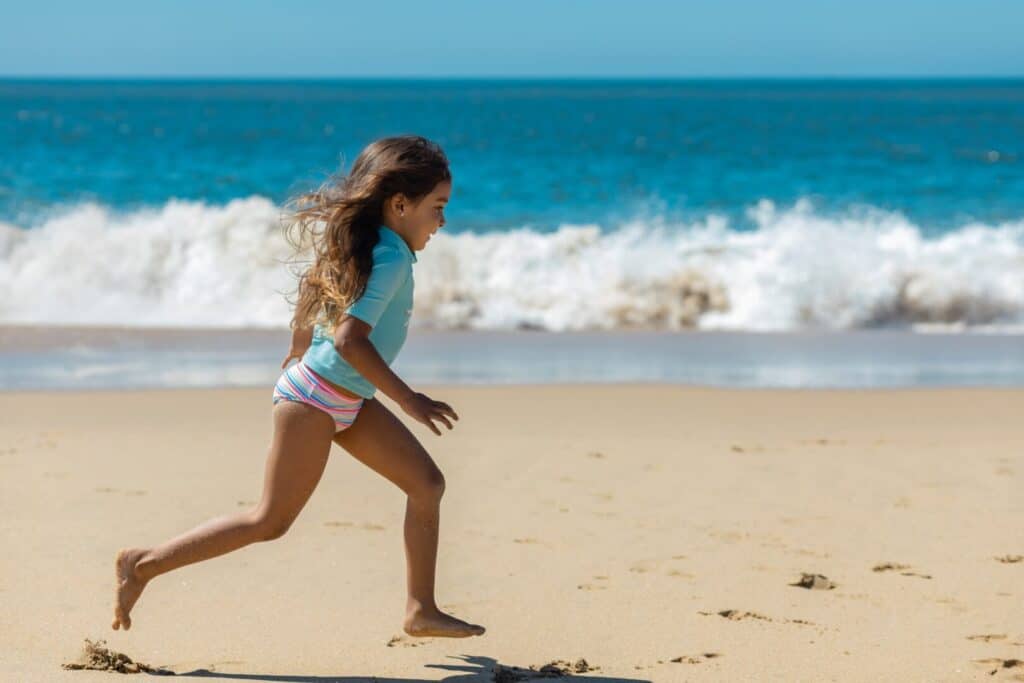 Young girl running on the beach