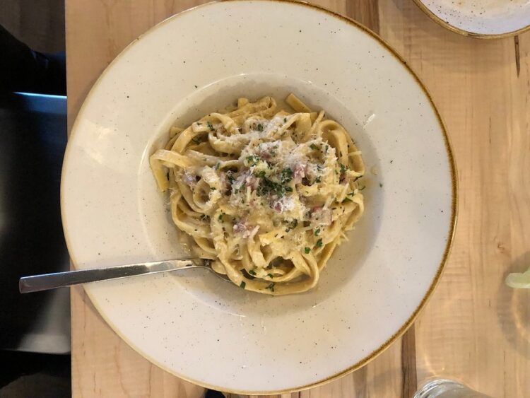 White plate with cooked quinoa noddles-cook quinoa like pasta