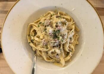 White plate with cooked quinoa noddles-cook quinoa like pasta