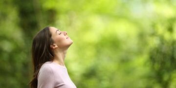 Let go of emotional baggage from past-woman breathing fresh air