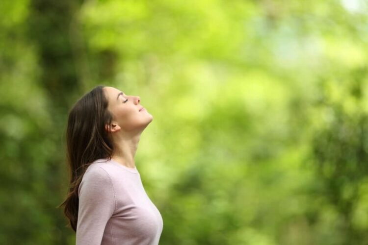 Let go of emotional baggage from past-woman breathing fresh air