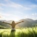 More joy in life - joyful woman in a field