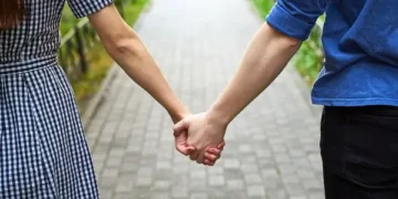 Couples holding hands in a parkway - dating rules book