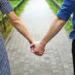 Couples holding hands in a parkway - dating rules book