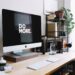 Office desk with computer, keyboard, trackpad, etc