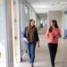 Two employees talking and walking along the alley