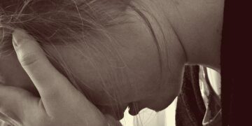 Woman holding her head after a failure