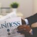Entrepreneur reading business newspaper