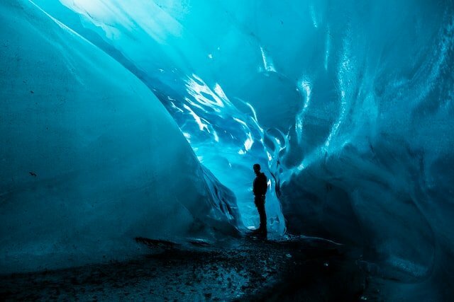 Foggy brain-person standing in ice cave during daytime