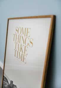 Photo frame with something take time written on it-what are the laws of attraction