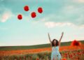 Things to remember during tough times in life-a moment of happiness of a woman in blue dress in a field of poppies