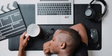 Man napping on his desk with silver laptop types of procrastination