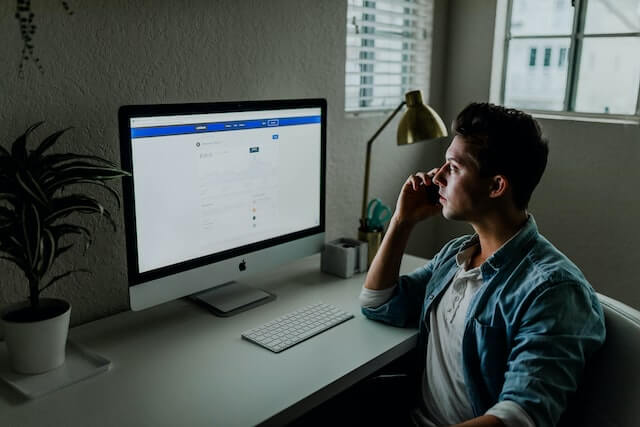 Man in blue denim facing a computer monitorDigital Marketer-Best job for introverts
