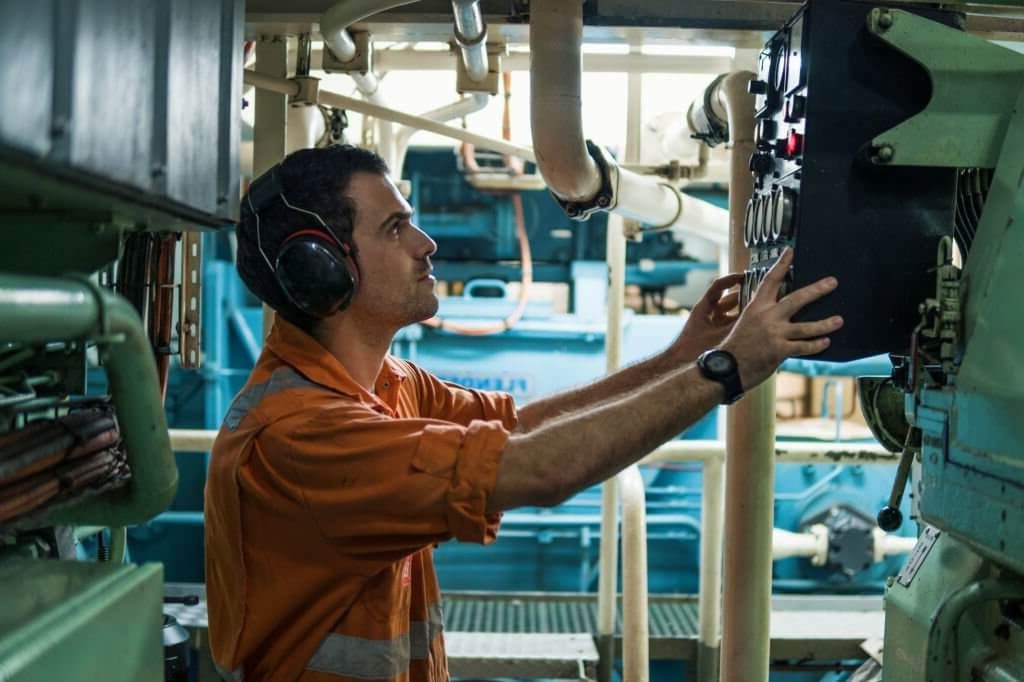Marine Engineer in orange coverall working inside a ship-jobs best for introvert