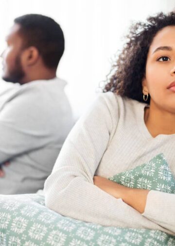 Moody couple sitting on sofa after an argument-handle emotional blackmail in a relationship