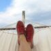 A man on hammock with a pair of red and white low top sneakers-five ways to turn being lazy into an advantage