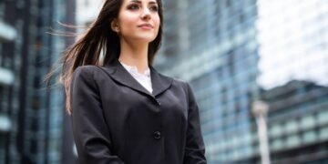 Business woman in black suit standing in front of high rise buildingstips for achieving great success