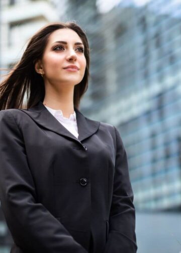 Business woman in black suit standing in front of high rise buildingstips for achieving great success