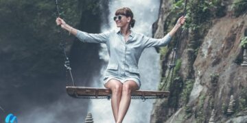 Beautiful woman swings near waterfall in the jungle of bali island-living your truth