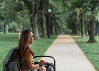 Single mom with child sitting in a park-thrive as a single mother