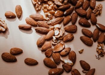 A brown almonds and walnuts on a flat surface-almonds glycemic index