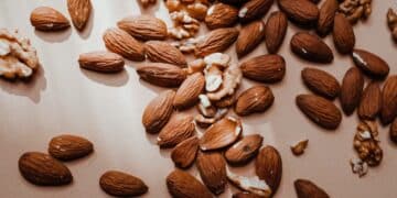 A brown almonds and walnuts on a flat surface-almonds glycemic index