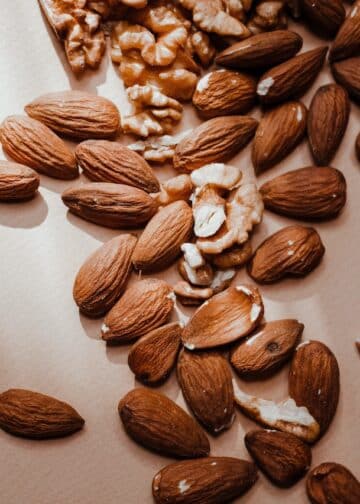 A brown almonds and walnuts on a flat surface-almonds glycemic index