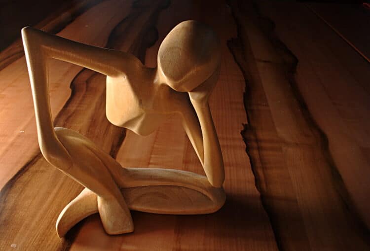 A wood figurine of a man thinking - how to figure out what to do with your life