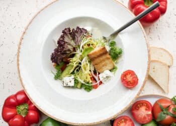 Sliced tomato and green vegetable on white ceramic plate-no sugar no grain diet